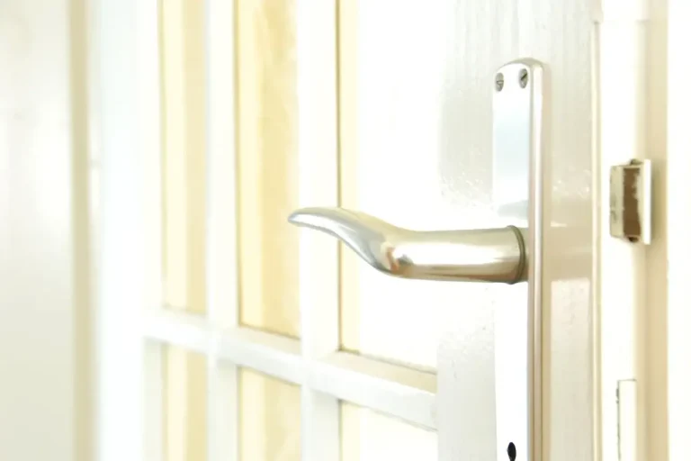 How to change a uPVC door lock in Birmingham – white door with a lever handle on a long backplate, Locksmith Birmingham guide to barrel, handle and multipoint replacement