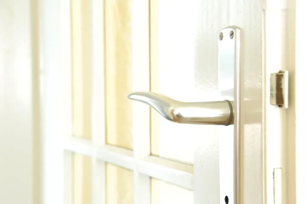 White uPVC door with a lever handle and locking plate – locksmith Kings Heath back-door lock repairs from Locksmith Birmingham